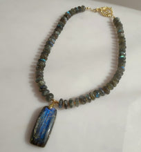 Load image into Gallery viewer, A beaded necklace made of blue and green labradorite beads with a large rectangular labradorite pendant, accented with 14 karqat gold-filled toggle clasp.