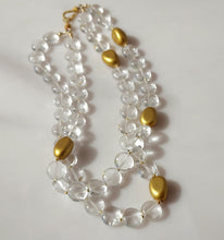 Load image into Gallery viewer, A double-strand necklace featuring clear crystal quartz smooth round beads and polished gold-colored oval accents, 14 karat gold filled findings.