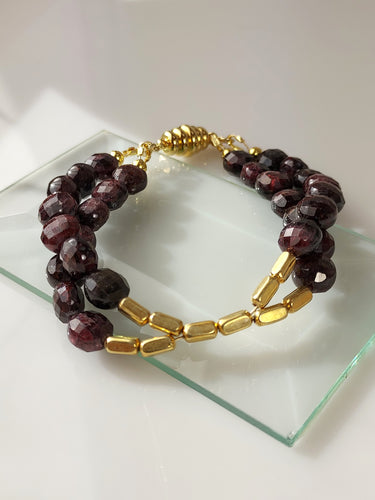 Faceted Garnet and gold double stranded bracelet.