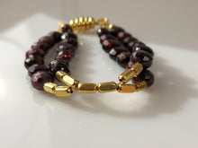 Load image into Gallery viewer, Gold and faceted Garnet double stranded bracelet with Magnetic clasp.
