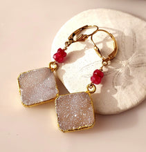 Load image into Gallery viewer, A pair of gold foiled edged square druzy stones, ruby faceted beads, and 14 karat gold-filled leverback closures.
