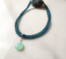 Load image into Gallery viewer, A beaded necklace with multiple strands of blue topaz beads and a teardrop-shaped Chrysopase green gemstone pendant, with Sterling silver findings.displayed on a light surface.
