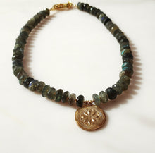 Load image into Gallery viewer, Labradorite beaded necklace featuring dark green, blue and gray labradorite stones with a handmade and kiln fired Bronze circular medallion pendant. 14 karat gold-filled toggle clasp.
