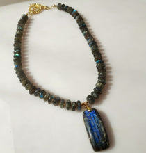 Load image into Gallery viewer, A beaded necklace made of blue and green labradorite beads with a large rectangular labradorite pendant, accented with 14 karqat gold-filled toggle clasp.

