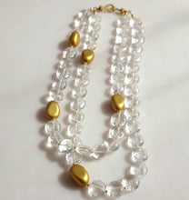 Load image into Gallery viewer, A double-strand necklace featuring clear crystal quartz smooth round beads and polished gold-colored oval accents, 14 karat gold filled findings. 
