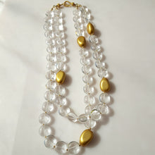 Load image into Gallery viewer, A double-strand necklace featuring clear crystal quartz smooth round beads and polished gold-colored oval accents, 14 karat gold filled findings. 
